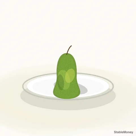 a green pear on a white plate